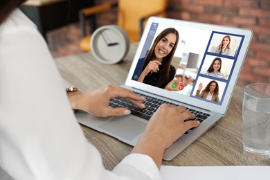 Image of Woman having video chat with team at table, closeup