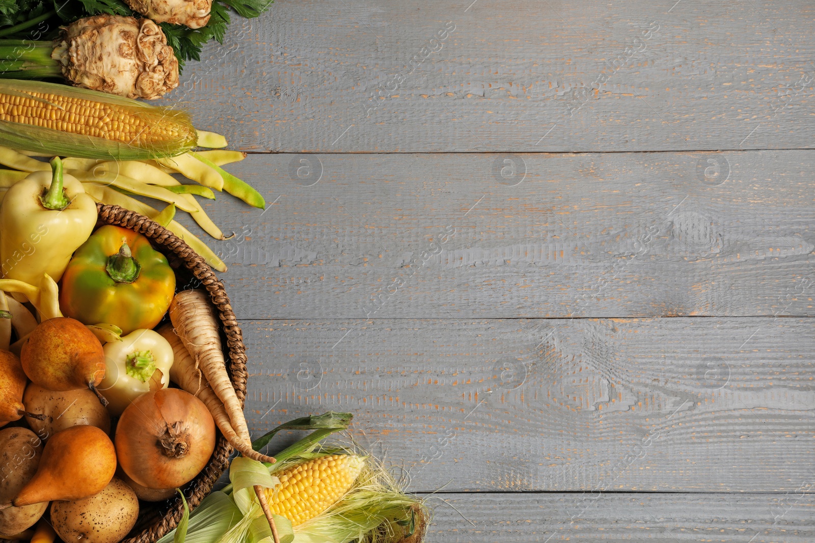 Photo of Different fresh ripe vegetables and fruits on grey wooden table, flat lay. Space for text