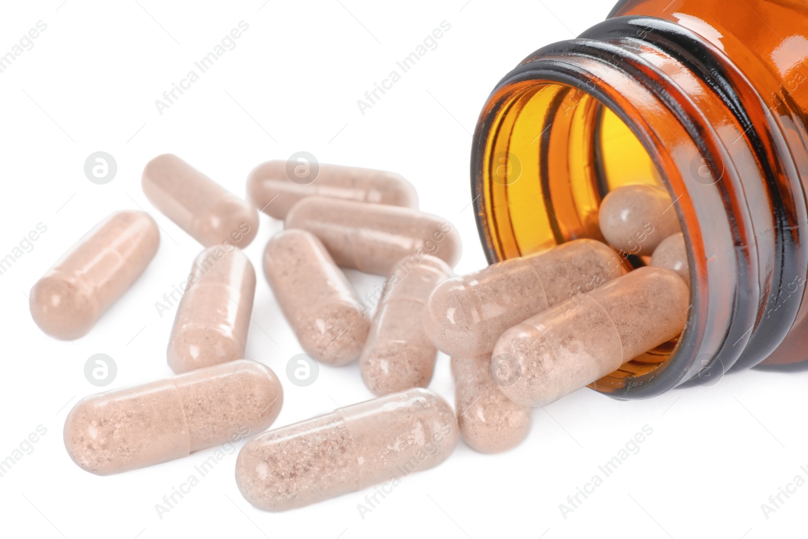 Photo of Gelatin capsules and bottle on white background