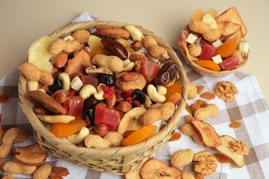 Mixed dried fruits and nuts on beige background