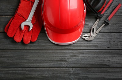 Flat lay composition with safety equipment and space for text on wooden background