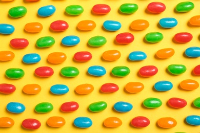 Photo of Flat lay composition with delicious jelly beans on color background