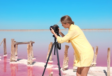 Photo of Professional photographer taking photo of pink lake on sunny day