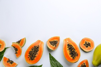 Fresh ripe papaya fruits on white background, flat lay. Space for text