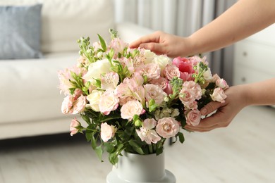 Woman with beautiful bouquet of fresh flowers at home, closeup