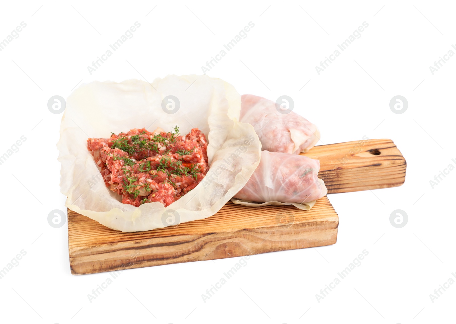 Photo of Wooden board with stuffed cabbage rolls isolated on white