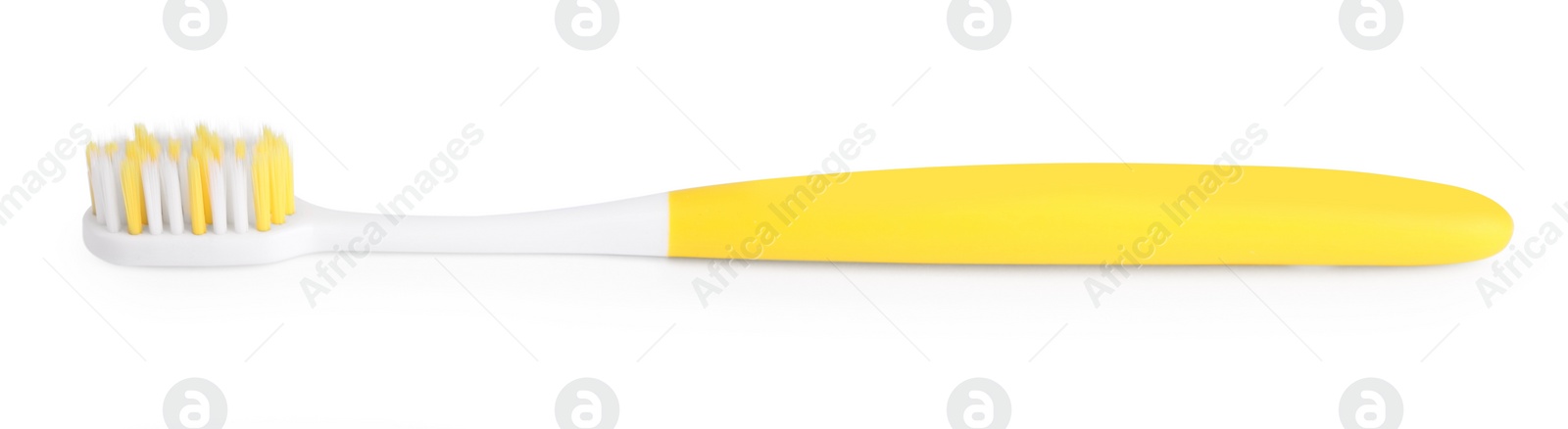 Photo of Yellow plastic toothbrush isolated on white. Dental care