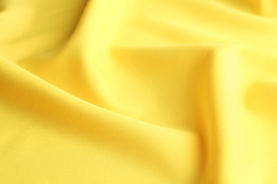 Photo of Texture of beautiful yellow fabric as background, closeup