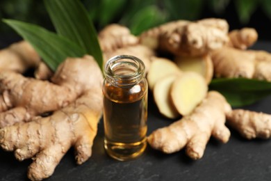 Ginger essential oil in bottle on dark table