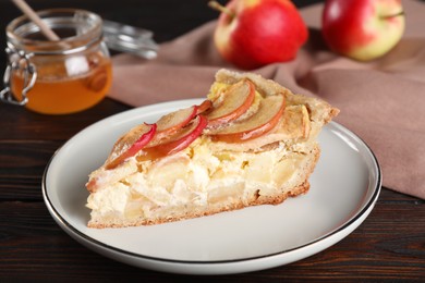 Photo of Piece of delicious homemade apple pie on wooden table