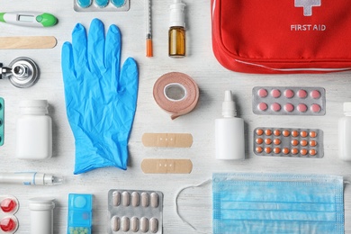 Photo of Flat lay composition with first aid kit on wooden background