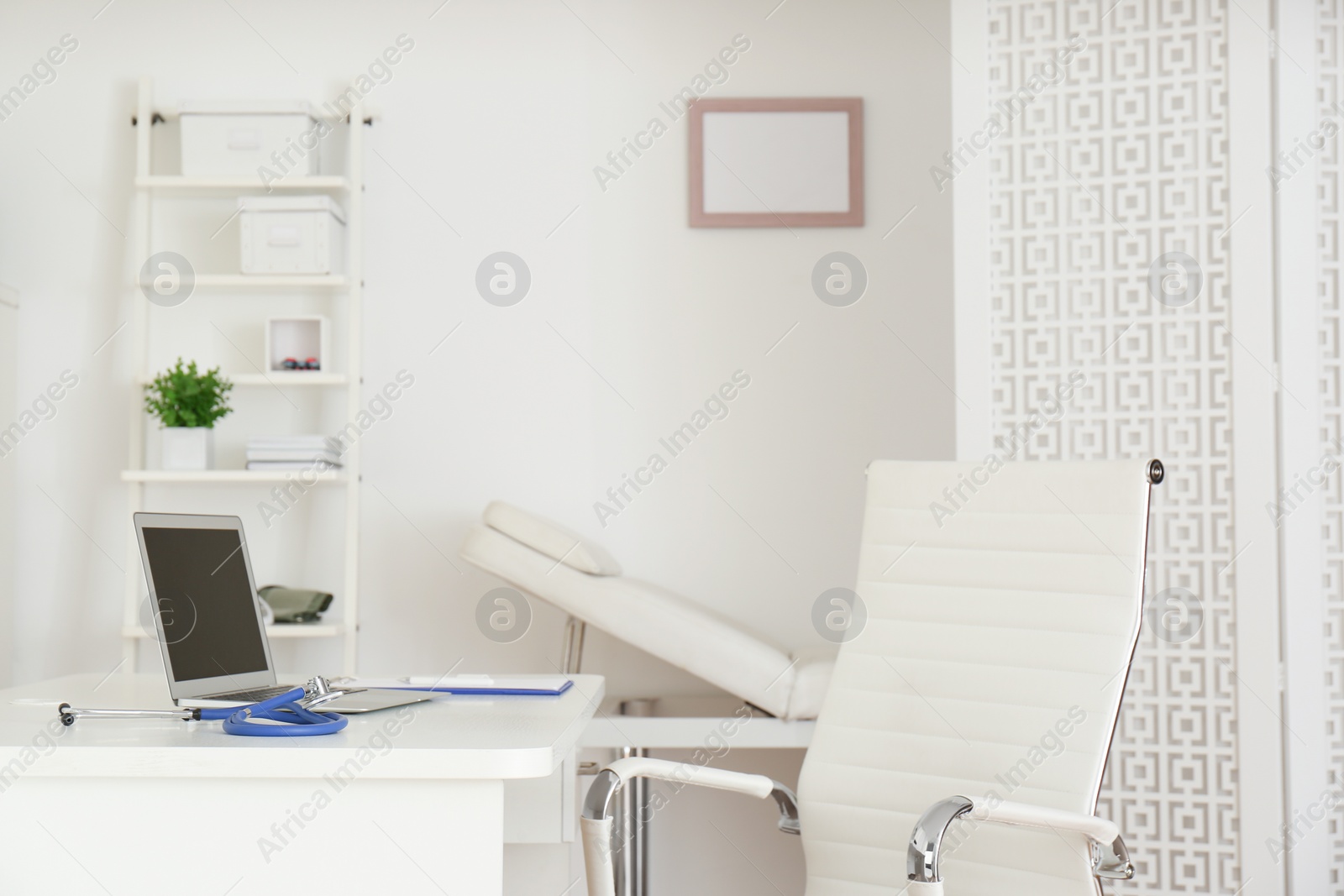 Photo of Doctor's workplace with modern laptop in medical office