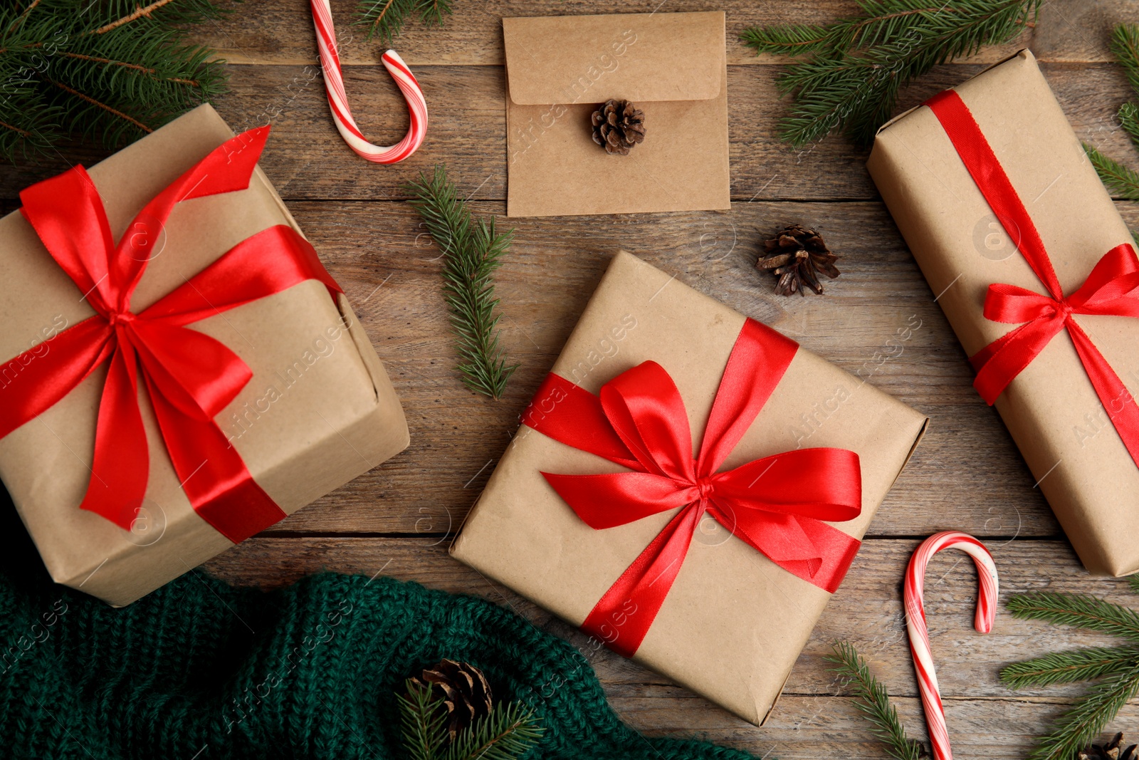 Photo of Flat lay composition with gift boxes and Christmas decor on wooden table