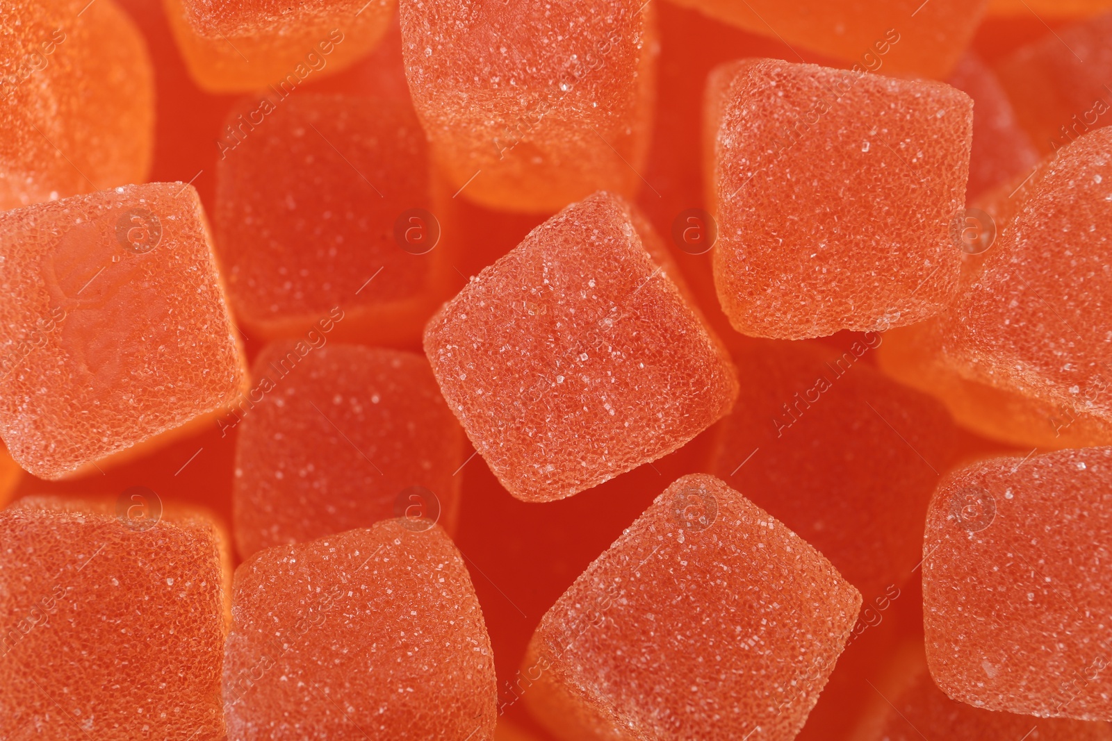 Photo of Tasty orange jelly candies as background, closeup