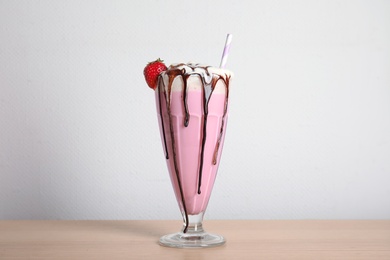 Photo of Glass of tasty milk shake on table