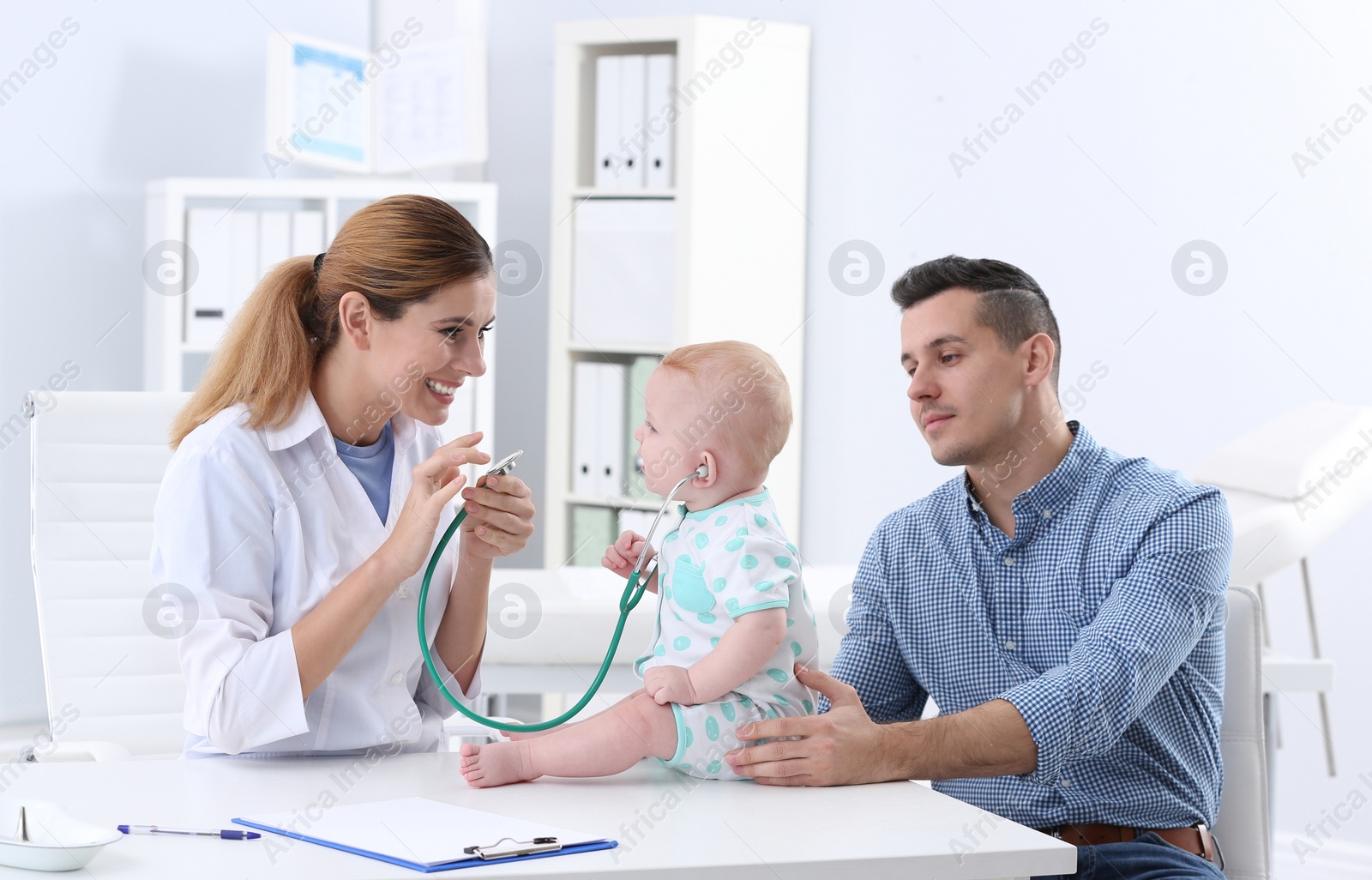 Photo of Man with his baby visiting children's doctor in hospital