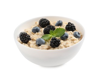 Photo of Tasty oatmeal porridge with blackberries and blueberries in bowl on white background