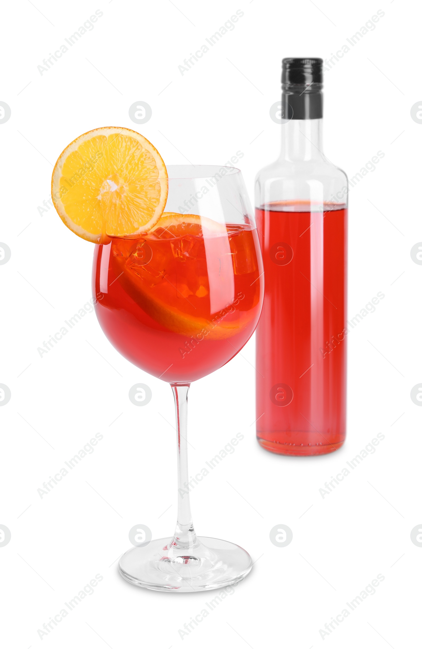 Photo of Bottle and glass of tasty Aperol spritz cocktail isolated on white