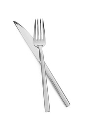 Fork and knife isolated on white, top view. Stylish shiny cutlery set