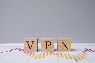 Photo of Cubes with acronym VPN on table against light grey background, space for text