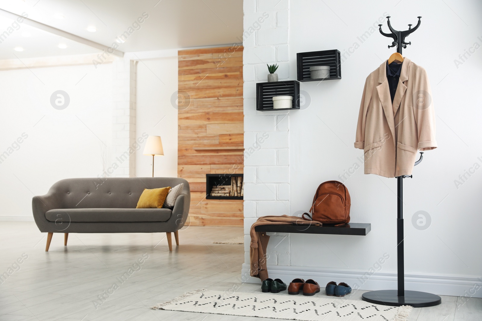 Photo of Hallway interior with stylish furniture, clothes and accessories