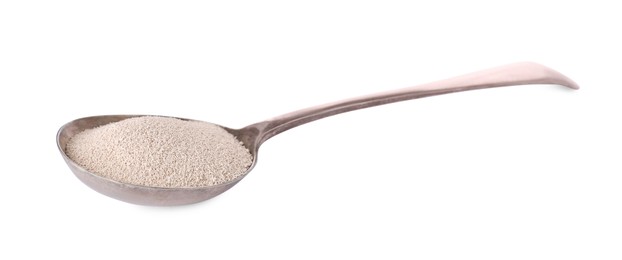Spoon with active dry yeast isolated on white