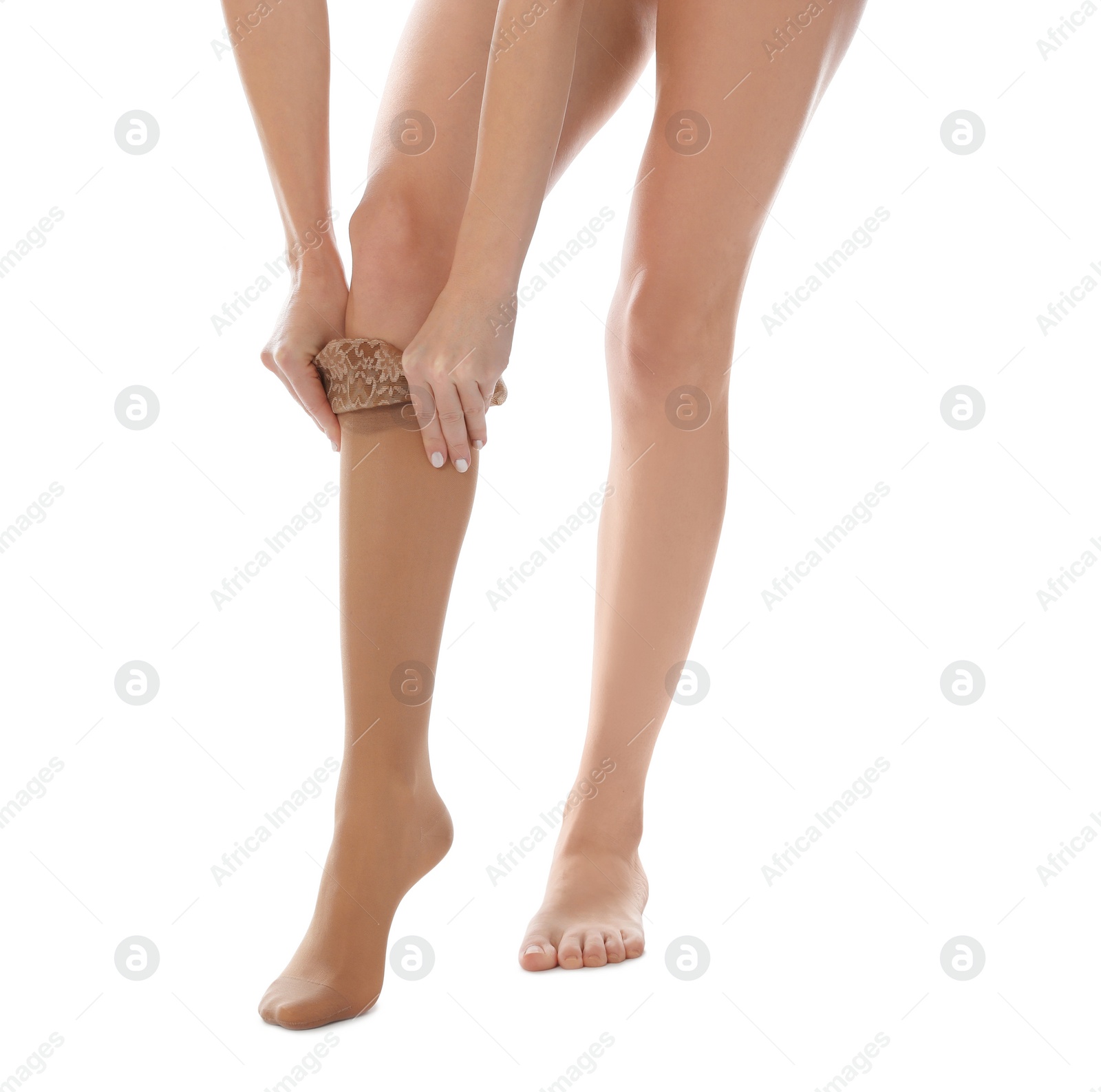 Photo of Woman putting on compression stocking against white background, closeup