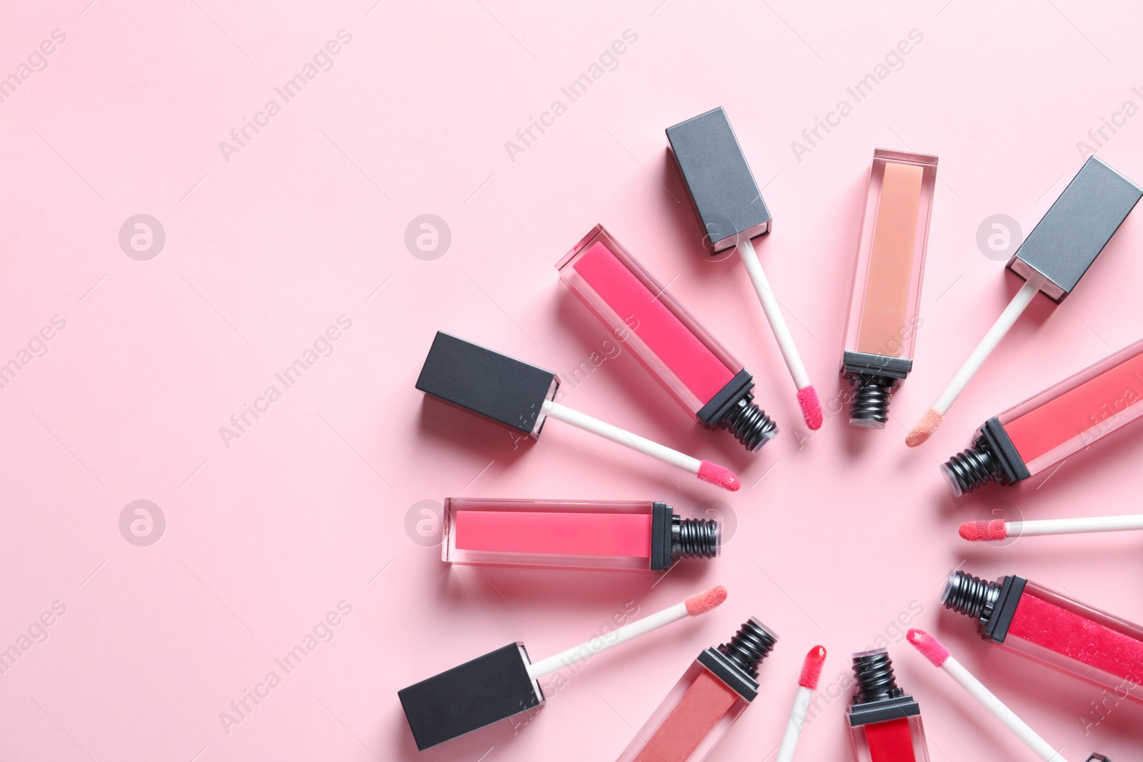 Photo of Composition of liquid lipsticks on color background, flat lay. Space for text