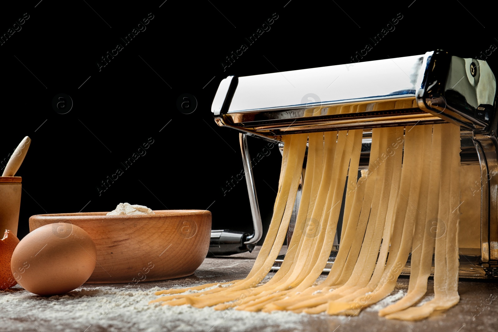 Photo of Pasta maker with dough and products on kitchen table