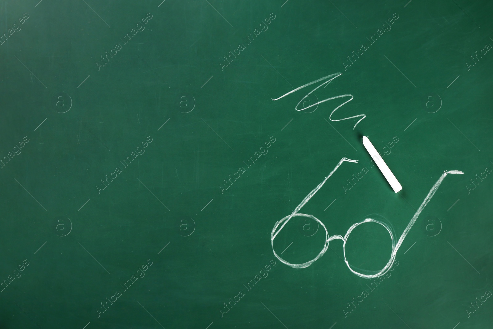 Photo of Drawing of glasses and chalk on board. Teacher's day celebration