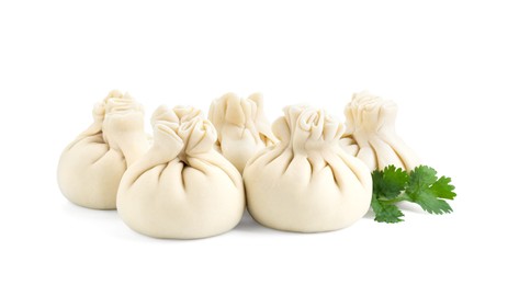 Uncooked khinkali (dumplings) and parsley isolated on white. Georgian cuisine