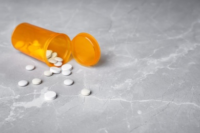 Bottle with pills on table