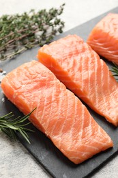 Photo of Fresh raw salmon and ingredients for marinade on light grey table