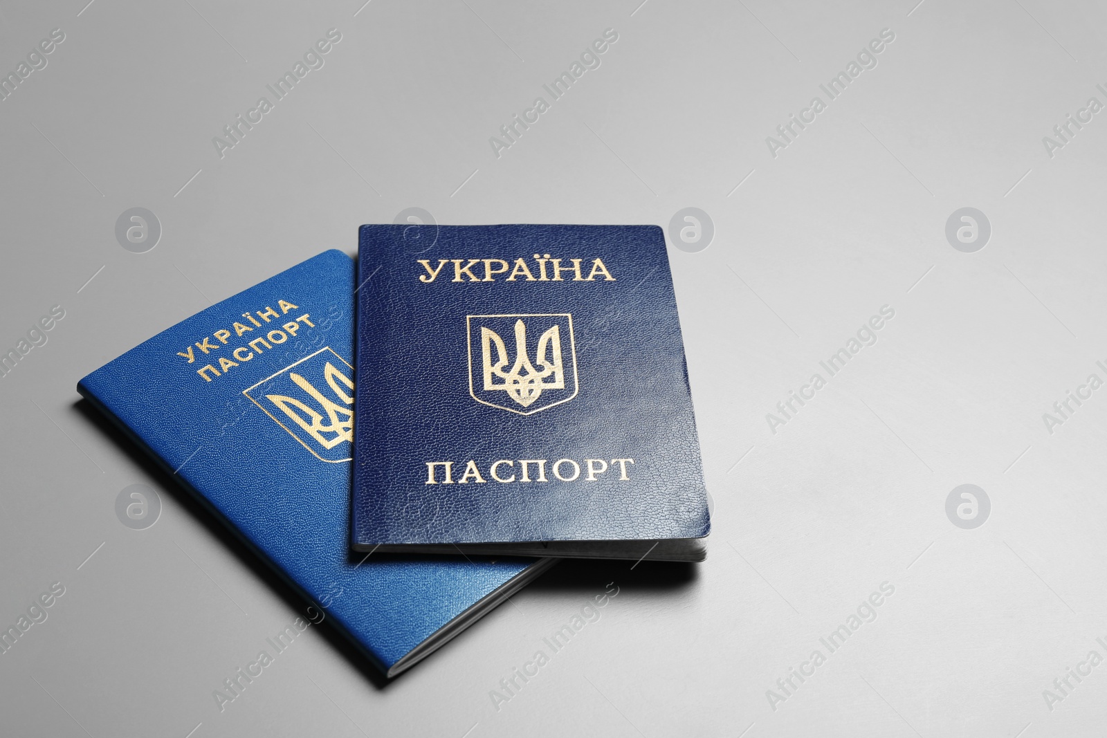 Photo of Ukrainian passports on grey background, space for text. International relationships