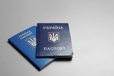 Ukrainian passports on grey background, space for text. International relationships