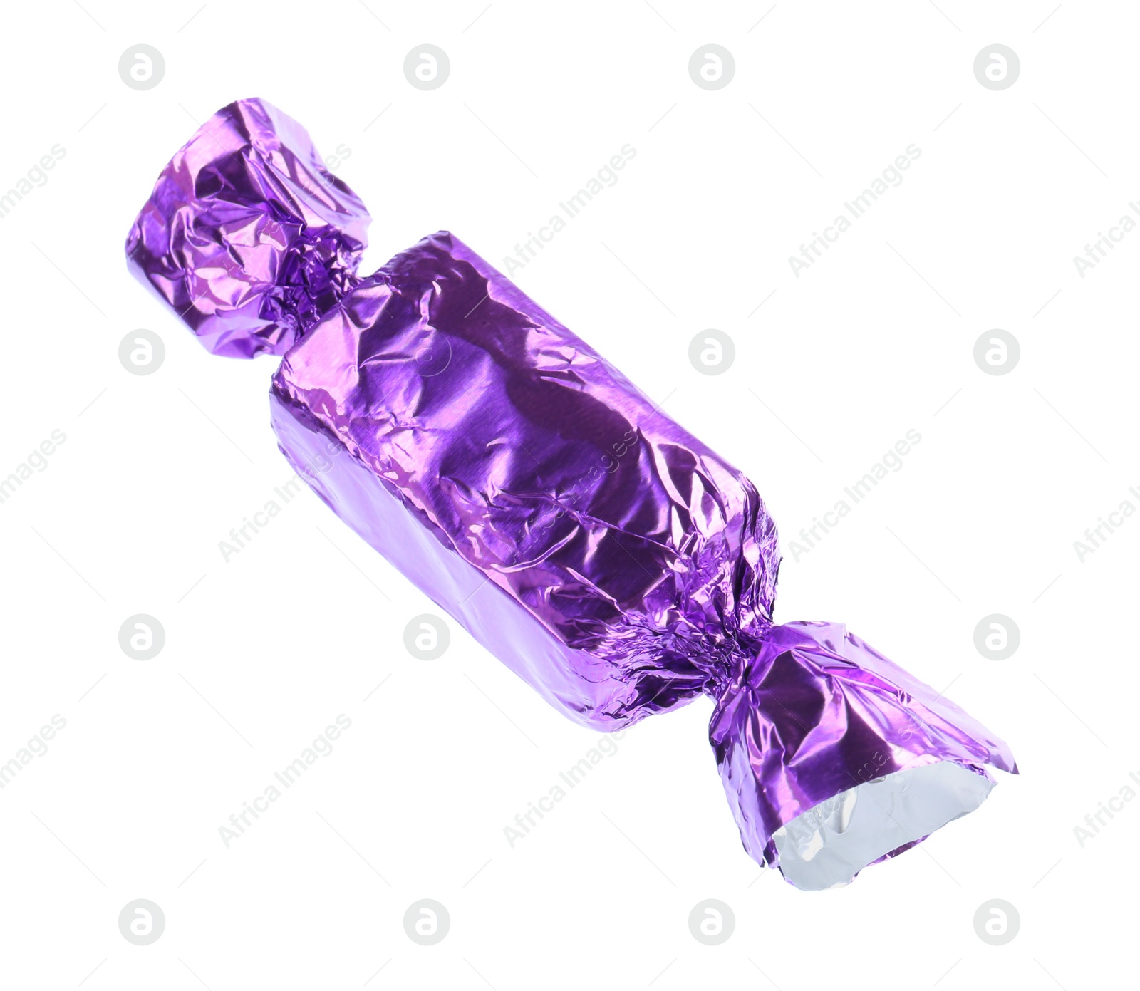 Photo of Tasty candy in purple wrapper isolated on white