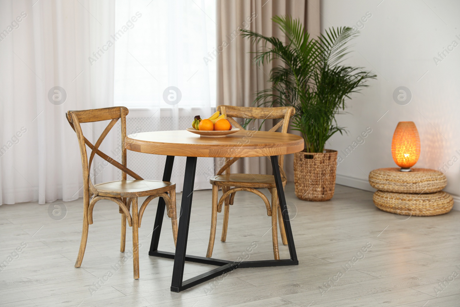 Photo of Stylish room interior with dining table and chairs