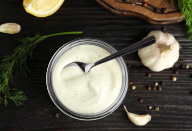 Photo of Flat lay composition with garlic sauce on wooden background