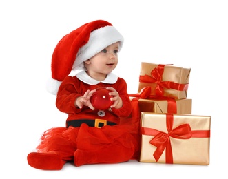 Photo of Festively dressed baby with gift boxes on white background. Christmas celebration