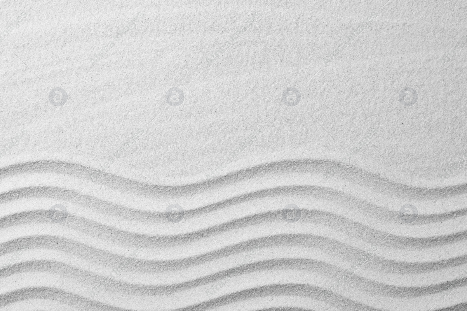 Photo of Zen garden pattern on sand as background, top view with space for text. Meditation and harmony