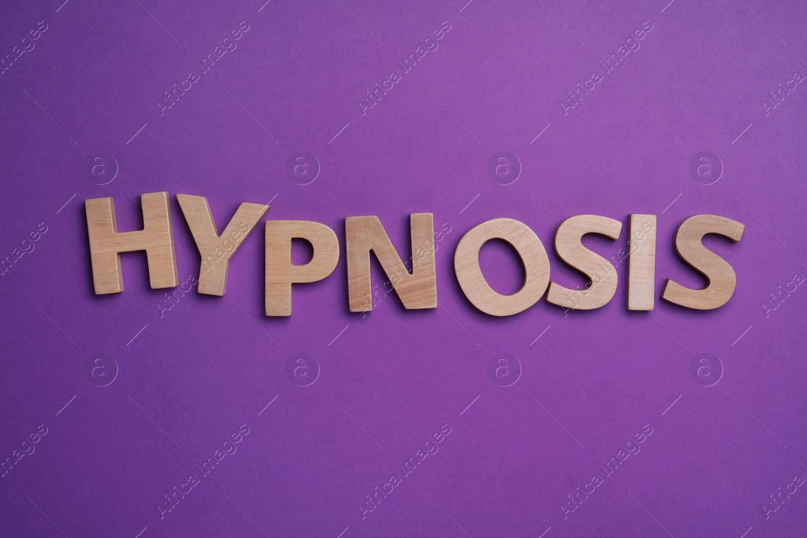 Photo of Word HYPNOSIS made with wooden letters on purple background, flat lay