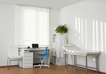 Photo of Interior of modern medical office with doctor's workplace