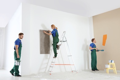 Photo of Professional decorators working indoors. Home repair service
