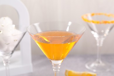 Photo of Tasty cocktails in glasses on gray table, closeup