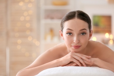 Photo of Beautiful young woman on massage table in spa salon