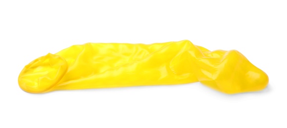 Photo of Yellow used condom on white background. Safe sex concept