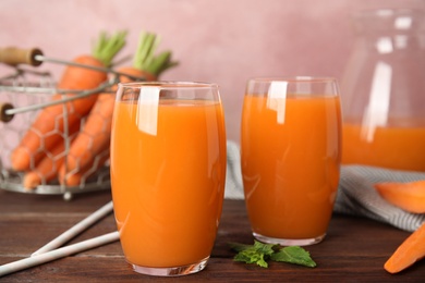 Freshly made carrot juice on wooden table