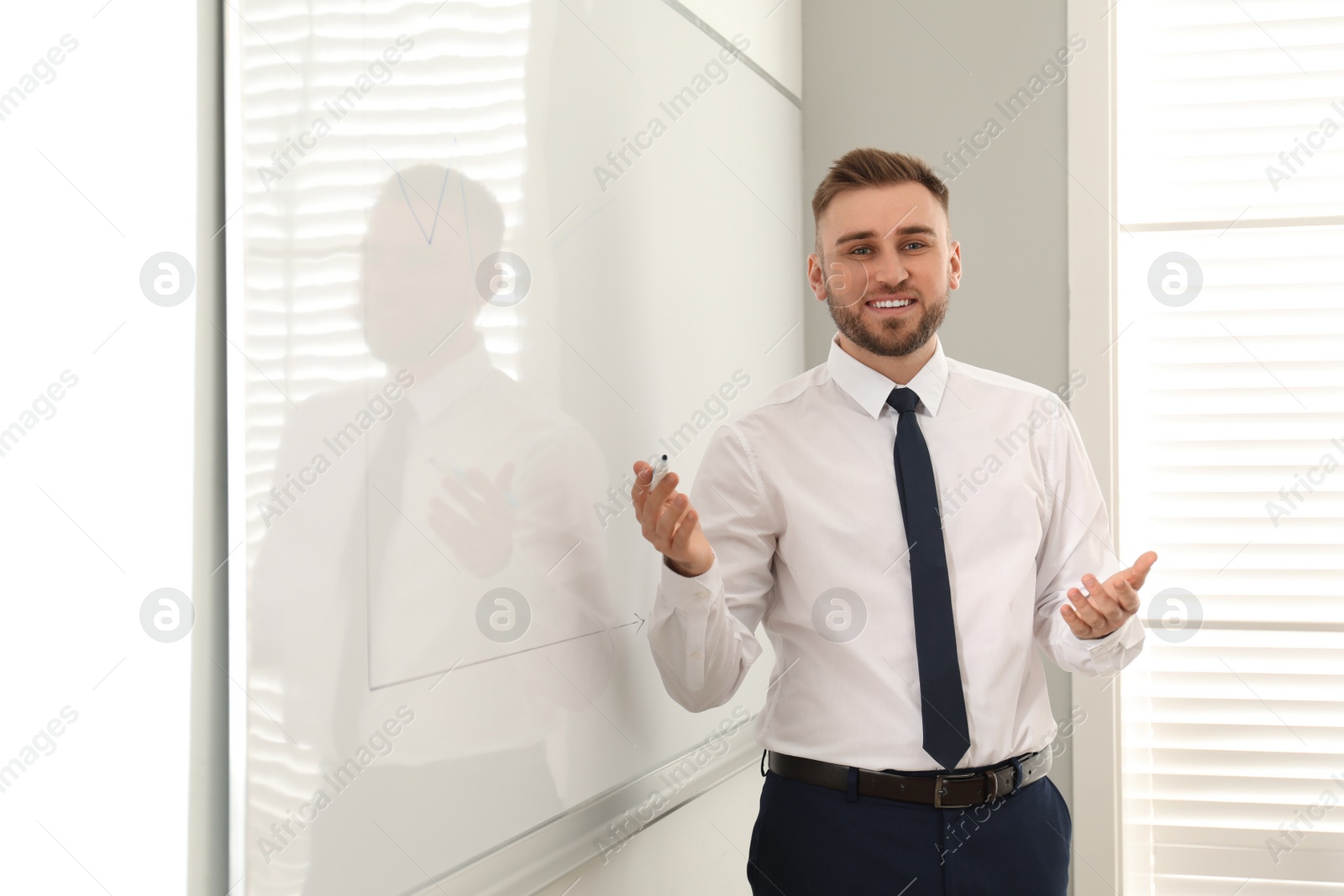 Photo of Professional business trainer near whiteboard in office