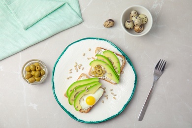 Photo of Tasty breakfast with crisp avocado  toasts on table, top view