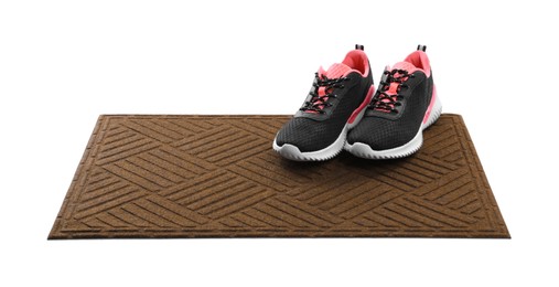 Photo of New clean door mat with shoes on white background